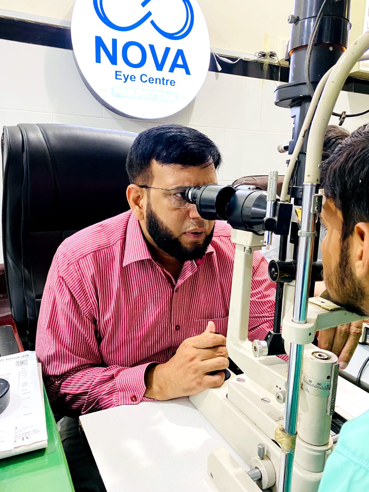 NOVA Eye Centre Pakpattan eye specialist examining a patient with a slit-lamp microscope